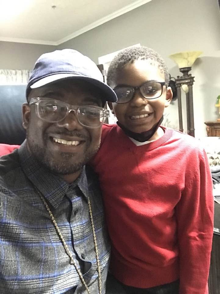 Bishop G. F. Austin III with his son at home