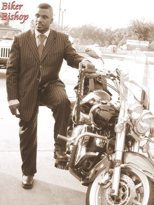 Bishop G. F. Austin III beside a motorcycle, styled as 'The Biker Bishop'