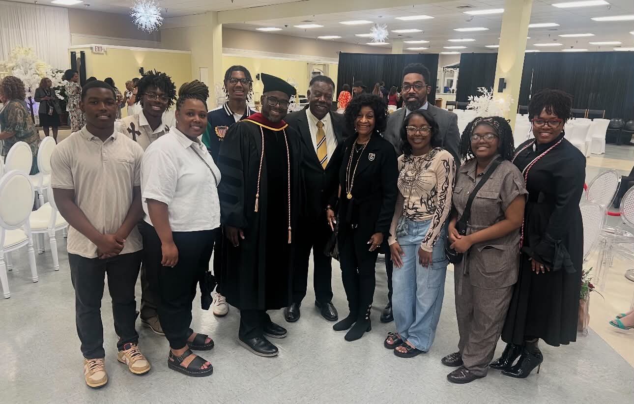 Bishop G. F. Austin III in graduation regalia with family