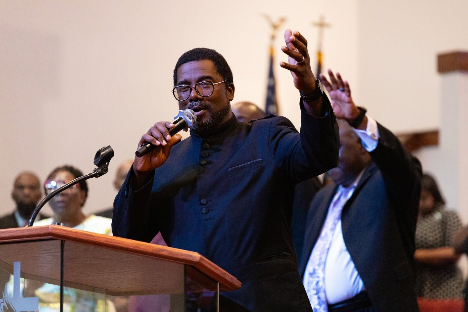 Bishop G. F. Austin III preaching with hands raised